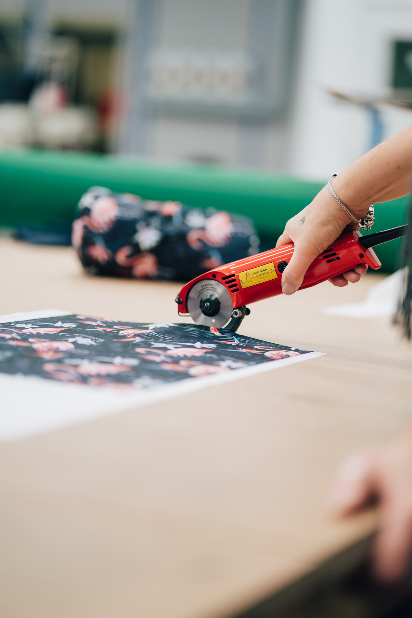 Someone cutting out the material for a head cover.