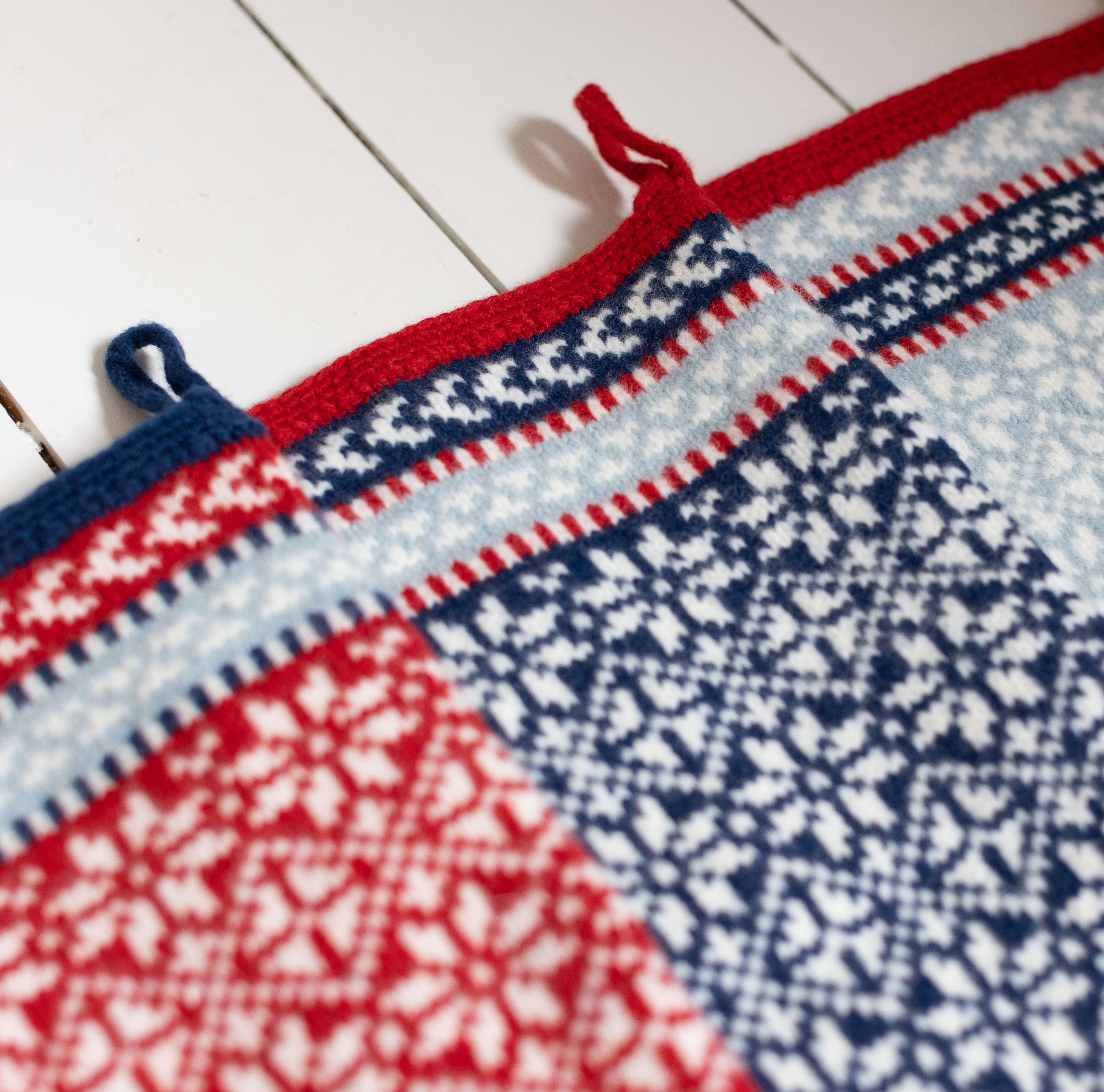 Scandinavian inspired knitted Christmas stocking in red, blue and white lambswool
