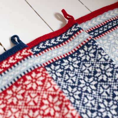 Scandinavian inspired knitted Christmas stocking in red, blue and white lambswool