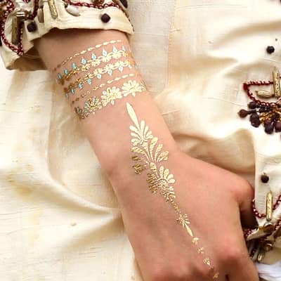 Karma Tattoos in gold, aquamarine & coral