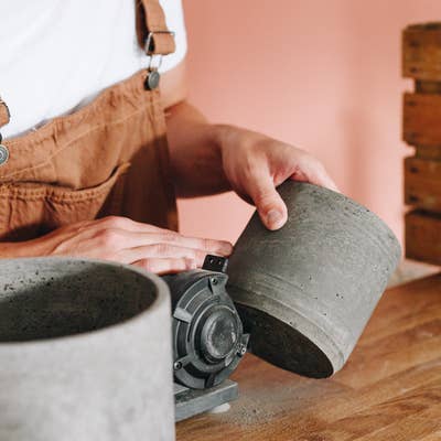 Sanding hand-cast recycled eco plant pot. Made in London