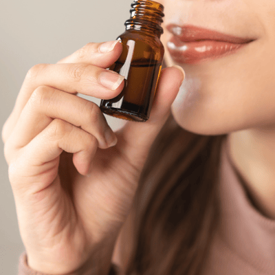A woman smelling an essential oil to feel relaxed