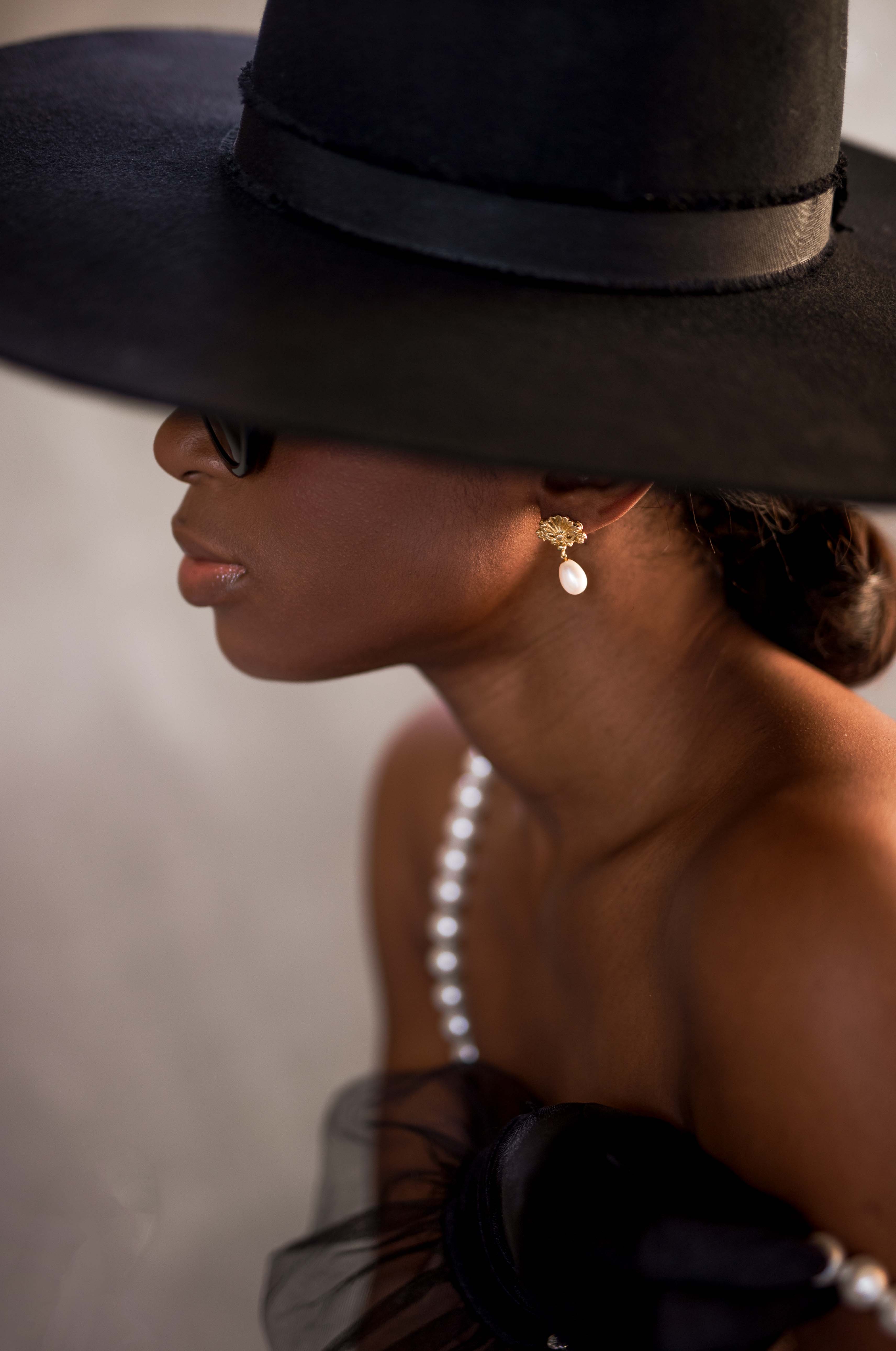 Model wearing pearl necklace and earring set