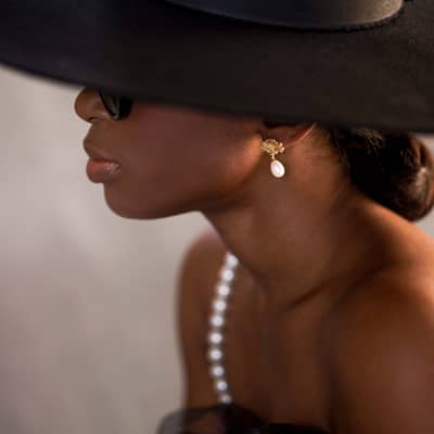Model wearing pearl necklace and earring set