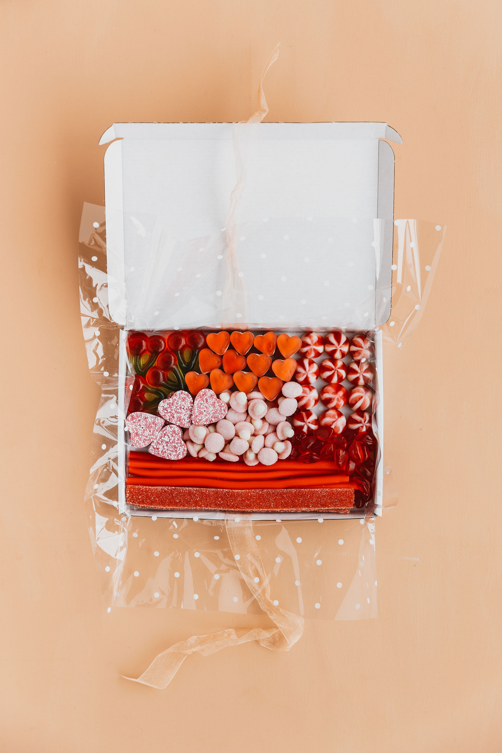 Our Pink & Red box open on a peach backdrop