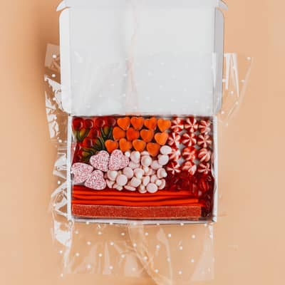 Our Pink & Red box open on a peach backdrop