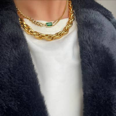 Layering chunky gold chains with gemstones