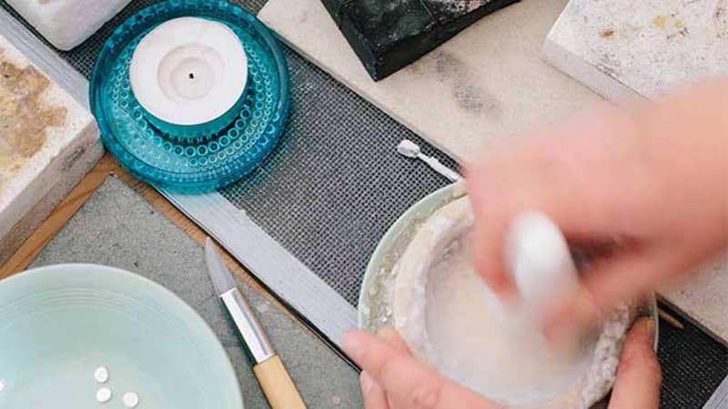 Mixing borax flux before silver soldering in the studio