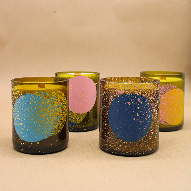 Collection of spray painted wine bottle candles inspired by the stars and planets