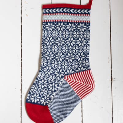 Scandinavian inspired knitted Christmas stocking in red, blue and white lambswool