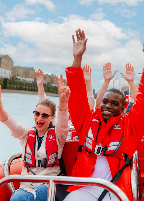 Passengers on a Thames Rockets London speedboat enjoying a speed section around Canary Wharf. Unique London Activity.  