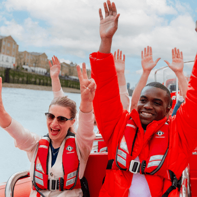 Passengers on a Thames Rockets London speedboat enjoying a speed section around Canary Wharf. Unique London Activity.
