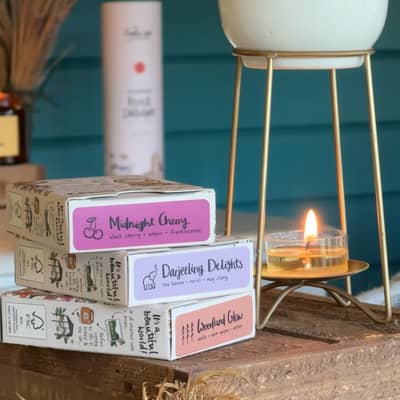 A shot of our Botanical Wax melts and the a selection of the scents we offer. In this image we have: Darjeeling Delights, Stargazer, Wonderland & Pear-Fect