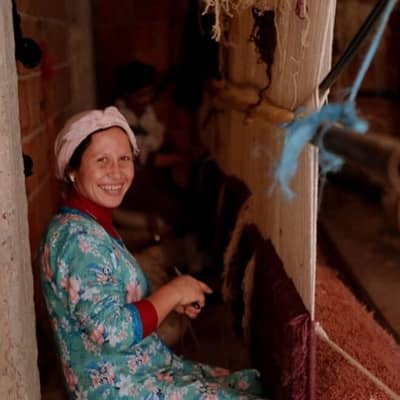 Female artisan using traditional hand loom