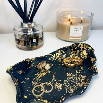 black and gold jewellery tray with diffuser and large candle