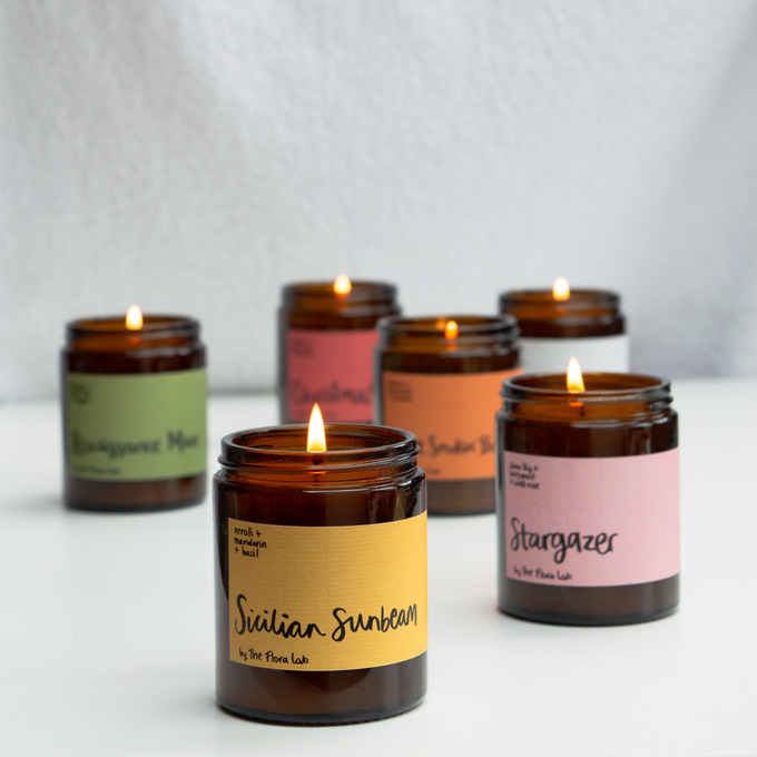 Our classic candle which has been opened. It shows the back and inner lid of the box, as well as the back side which details our 'candle with care' guide. 