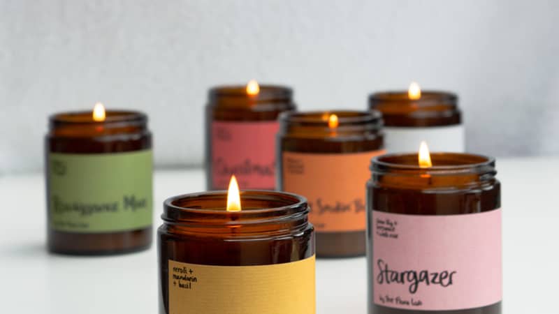 Our classic candle which has been opened. It shows the back and inner lid of the box, as well as the back side which details our 'candle with care' guide.