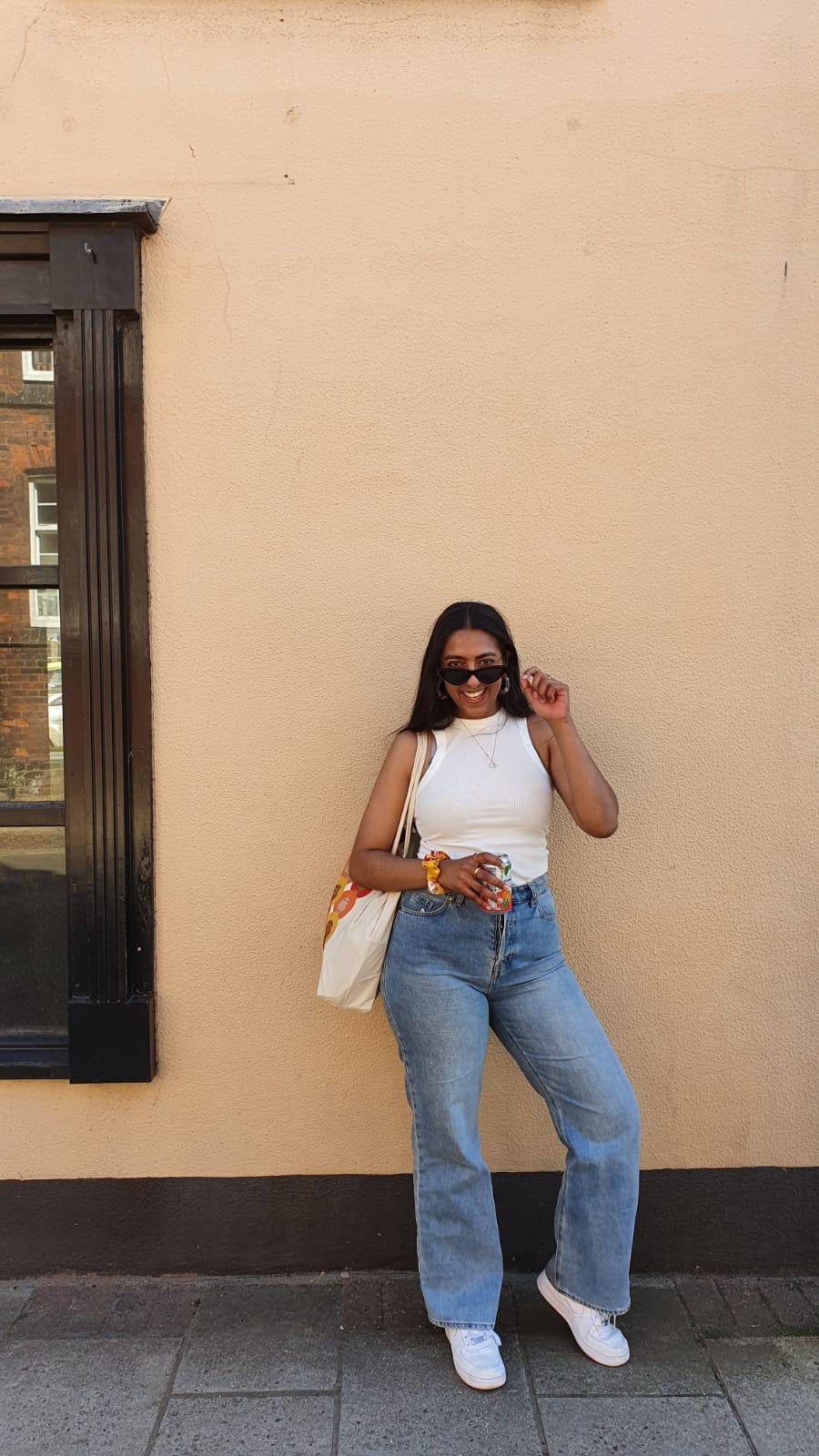 Shunayna against a yellow background, with the 'bald baddies' tote bag