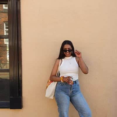 Shunayna against a yellow background, with the 'bald baddies' tote bag