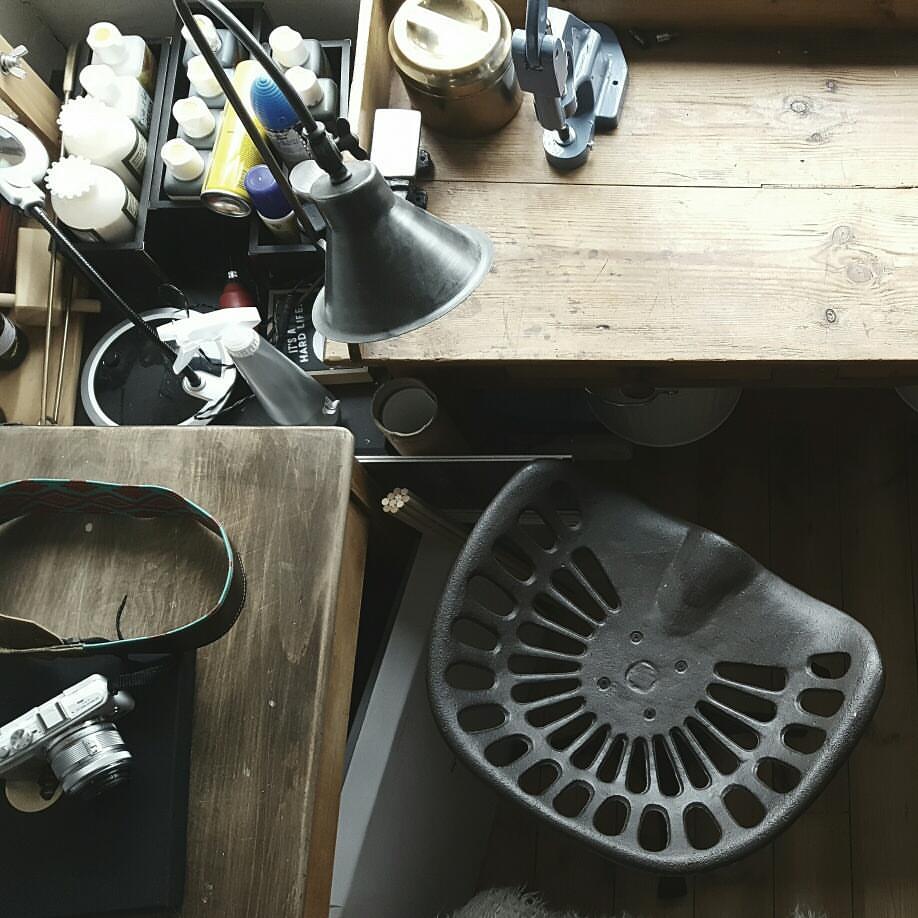 artist work space and studio with desk and stool