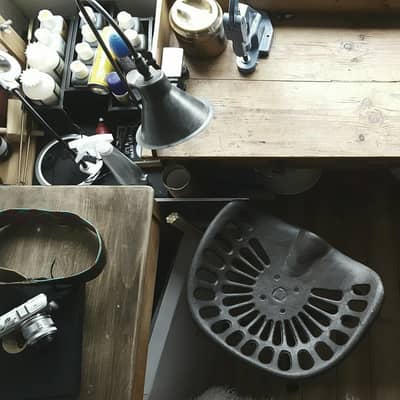 artist work space and studio with desk and stool