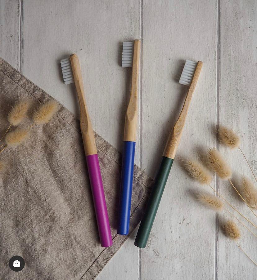 Three bamboo toothbrushes colours pink, blue and green 