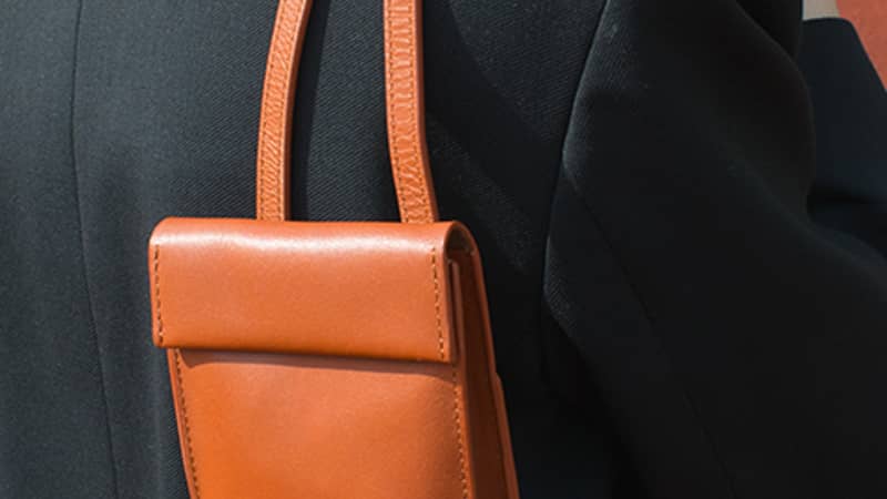 Rust Brown Phone Bag being held over the shoulder