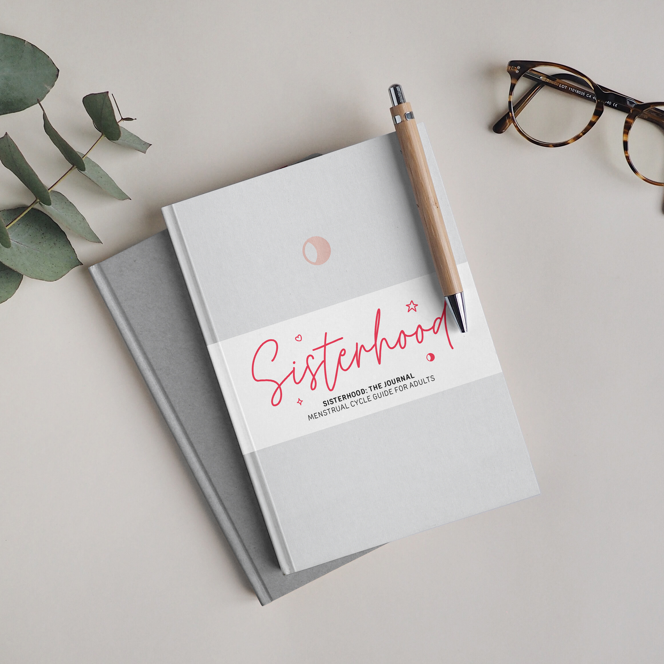 2 journals on table with pen and glasses