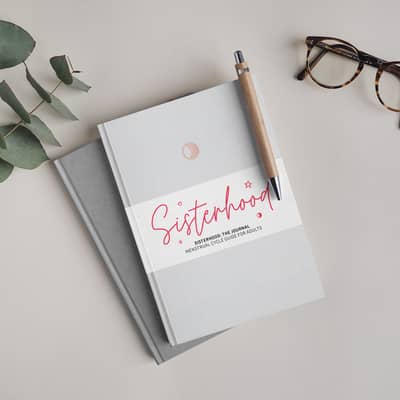 2 journals on table with pen and glasses