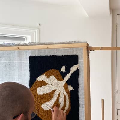 Each of our carpet cushions is tufted by hand using wool yarn before being sewn up by us in Brighton.