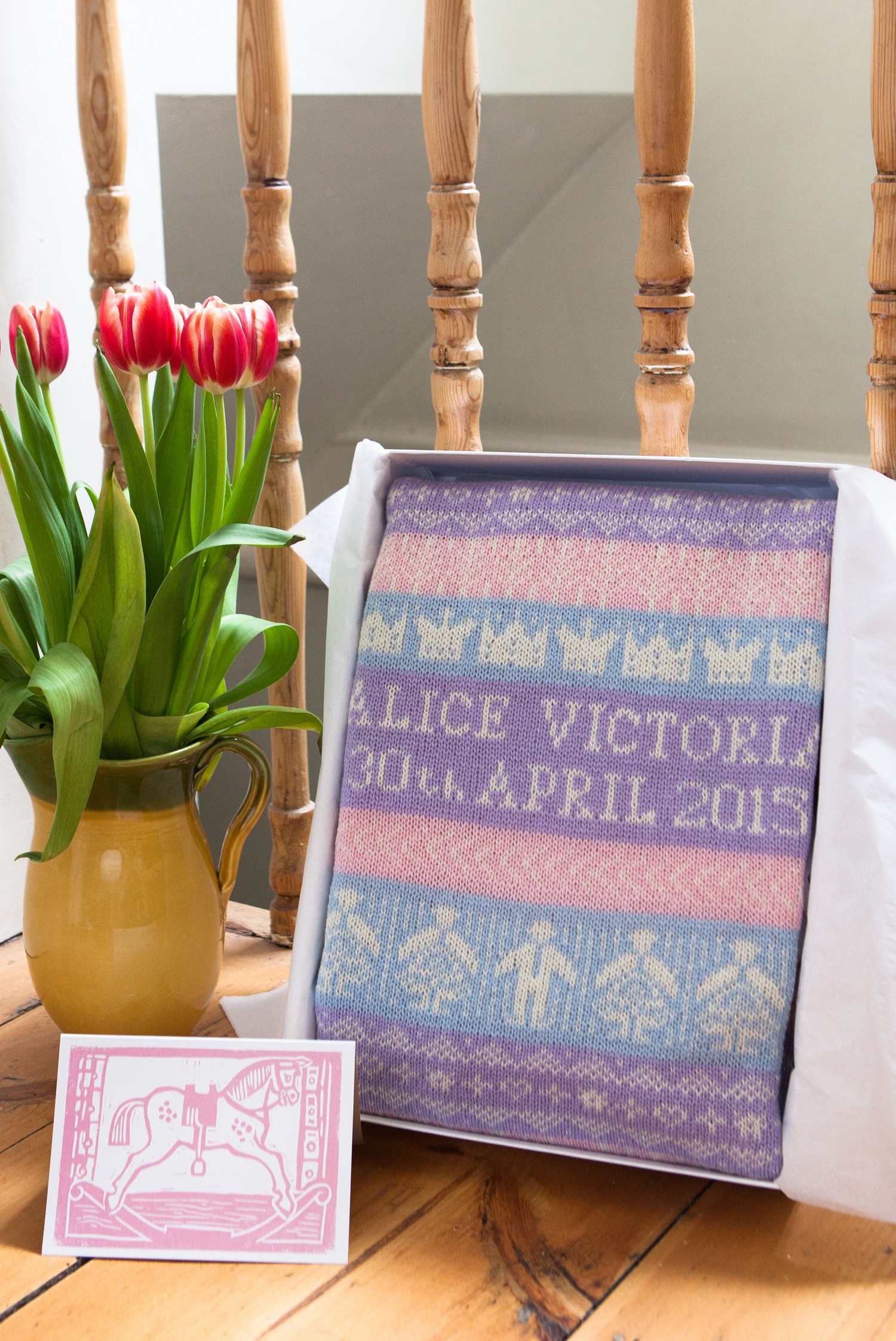 personalised baby blanket in presentation gift box on chair