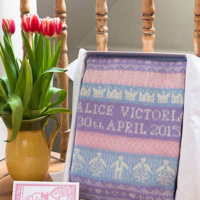 personalised baby blanket in presentation gift box on chair