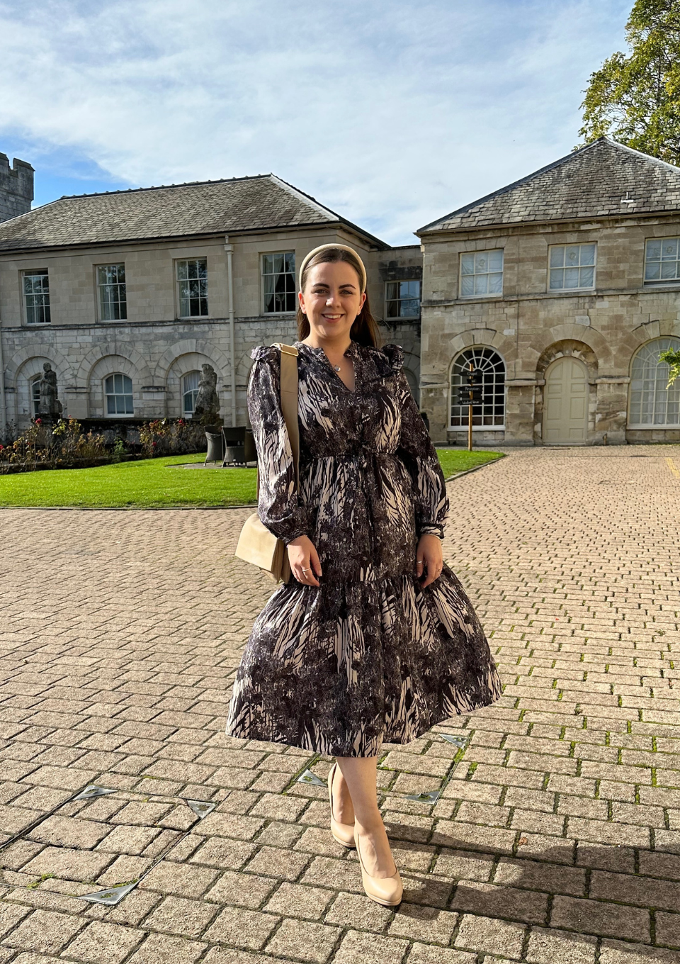 The owner of The Orchard Embroidery Co, Heather, stood outside in a formal dress.