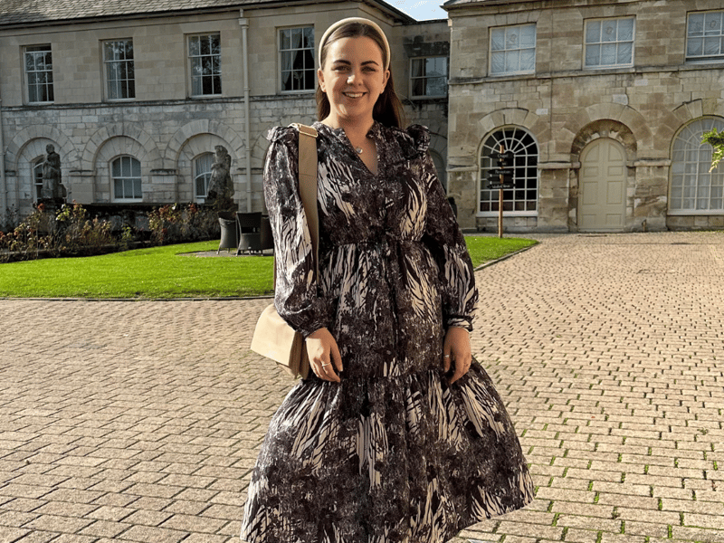 The owner of The Orchard Embroidery Co, Heather, stood outside in a formal dress.