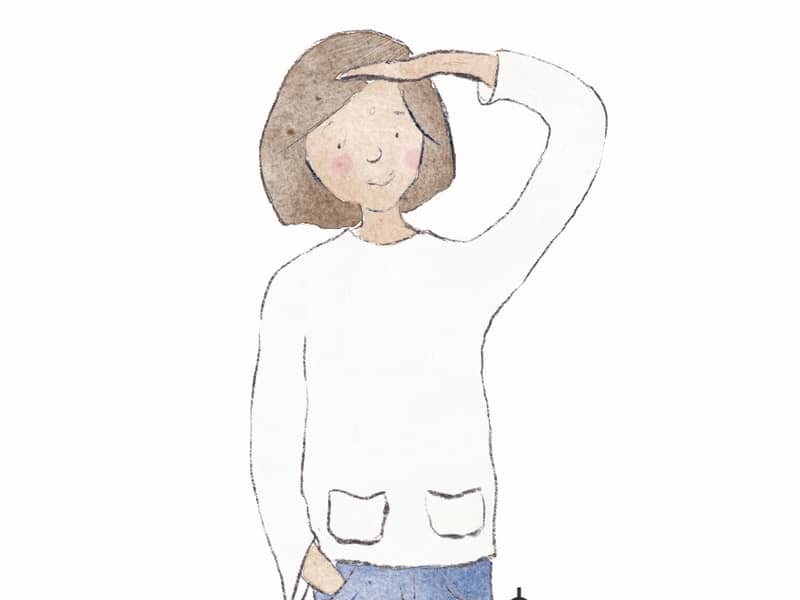 Headshot of Emma Bryan sitting in front of a floral print