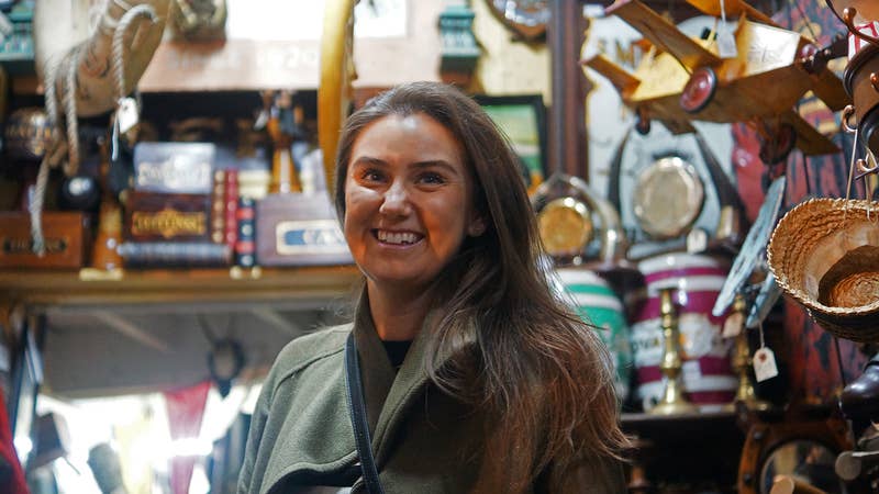 Charlotte hunting for vintage items in antique markets