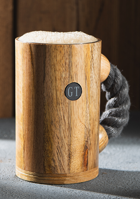 chuug rope handle coffee mug beer tankard with light rope and light oak wood finish outdoors in the mountains with pirate coin inlay