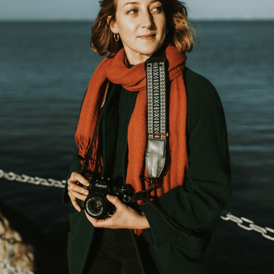 a portrait of a woman holding a camera