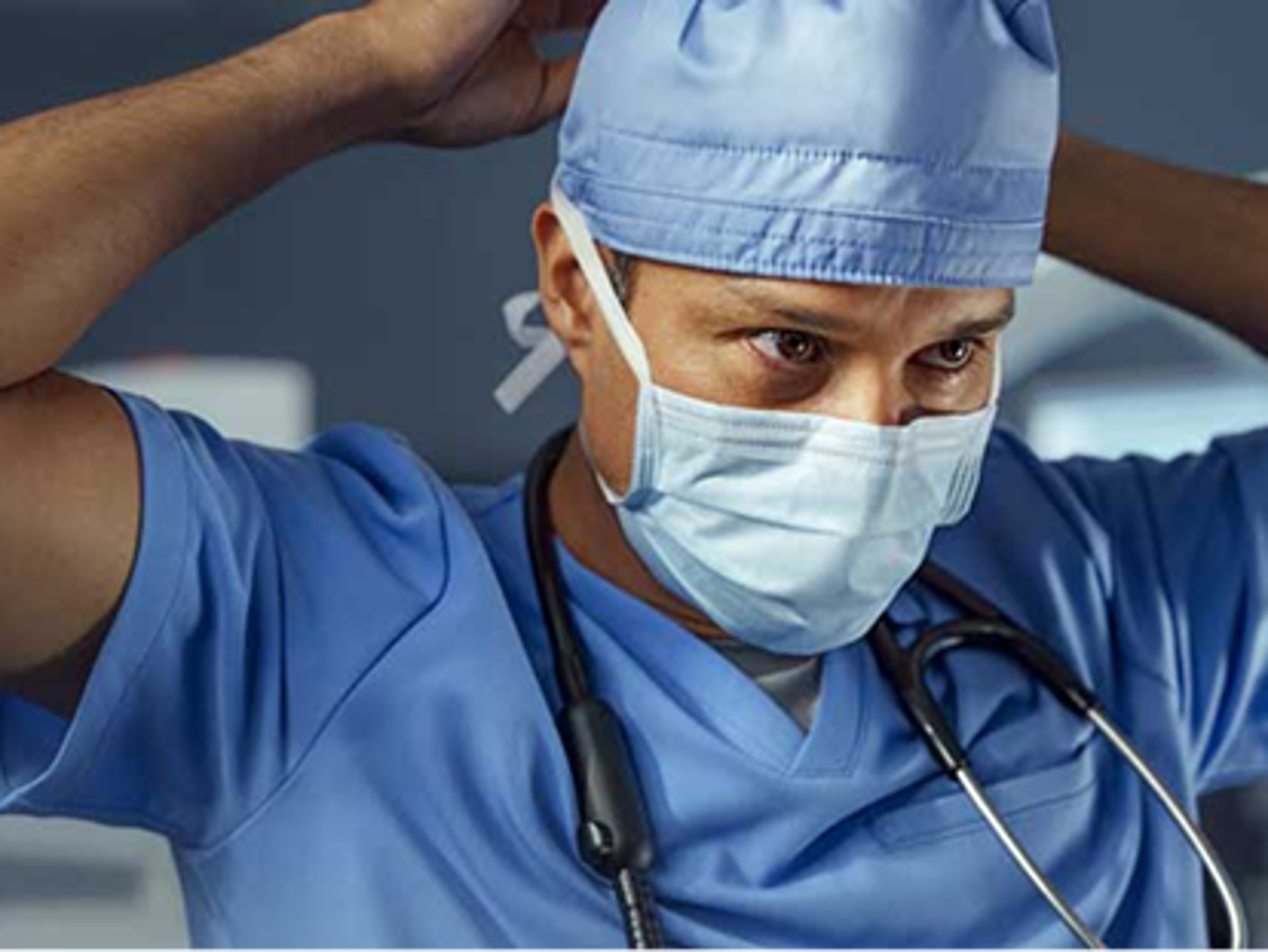 Surgeon putting on a surgical cap in preparation for surgery.