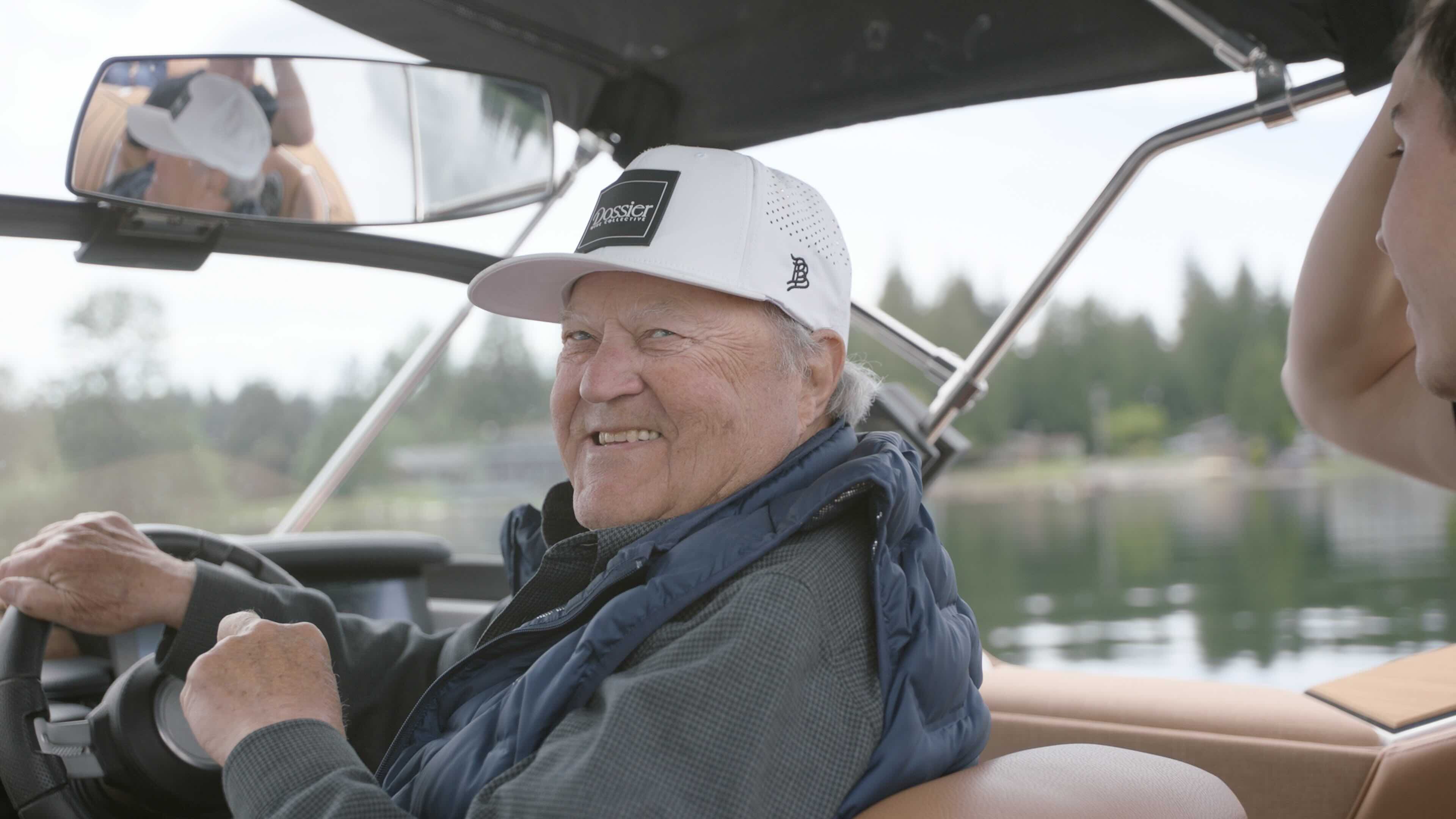 John Adams smiling while driving a boat on a lake, enjoying an active lifestyle years after his IVL treatment
