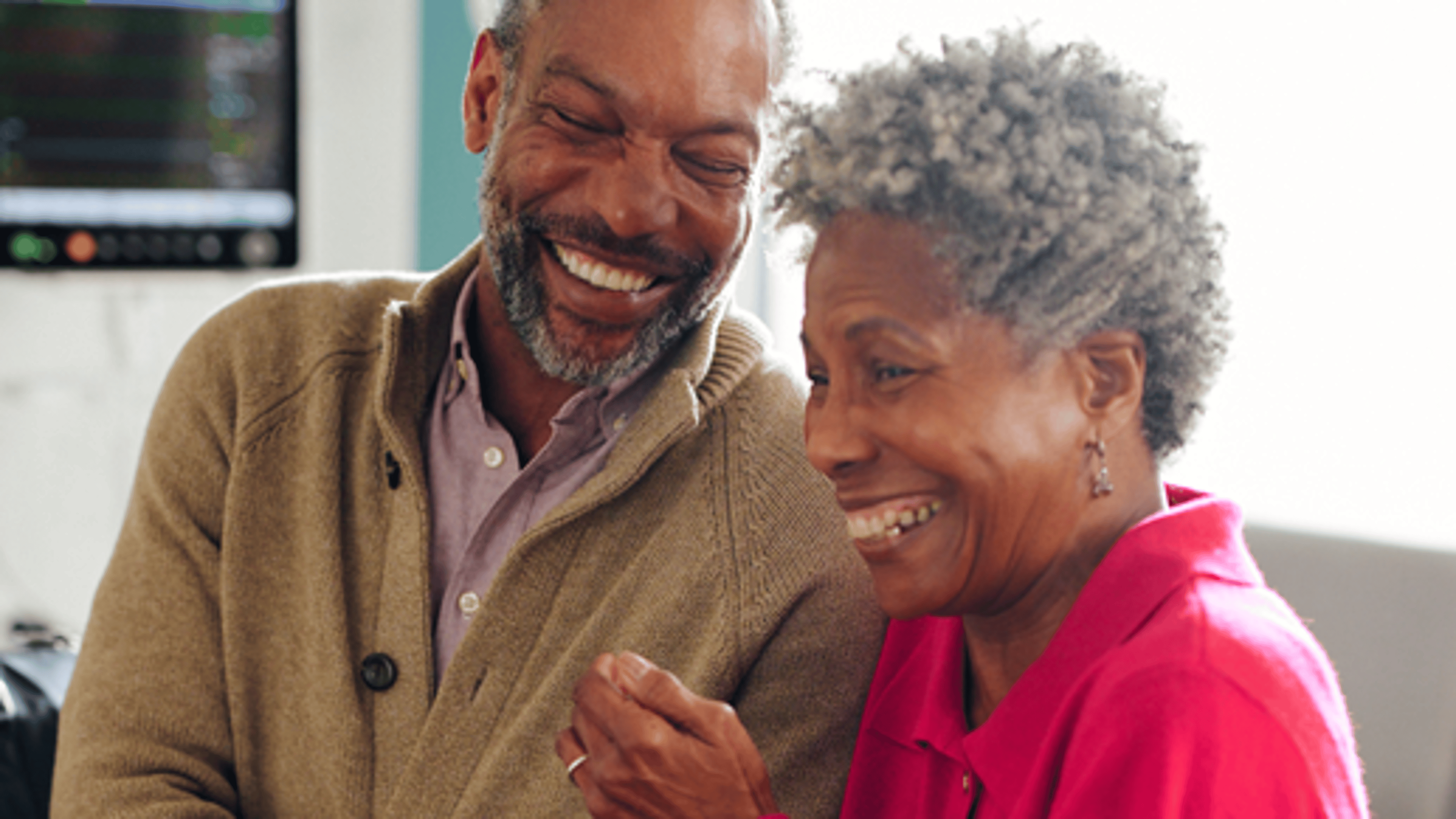 A couple laughing in the hospital room