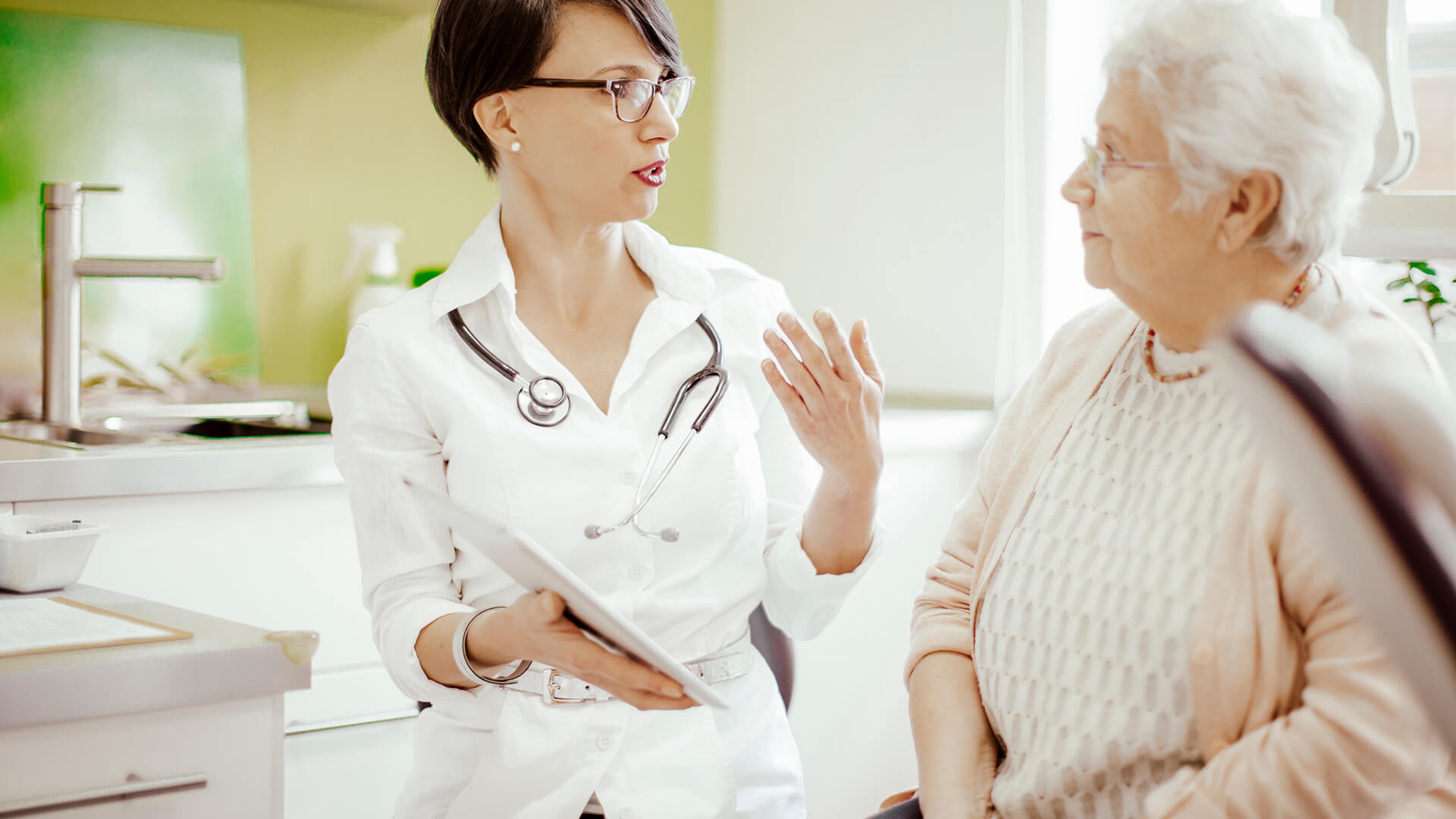 Doctor talking to older female patient about GERD