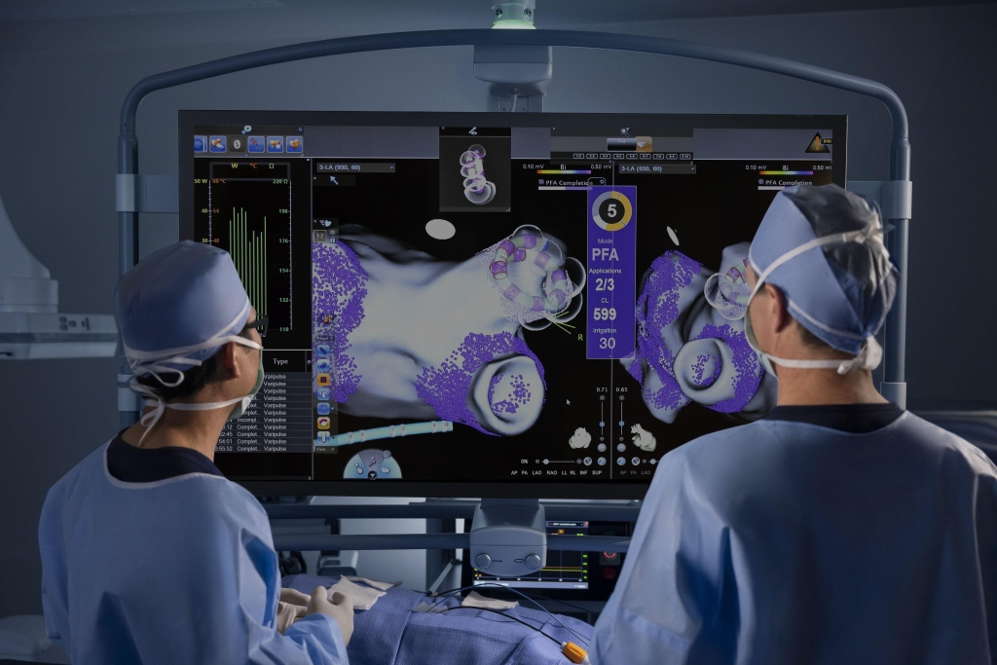 Two doctors reviewing a patient's x-ray on a monitor