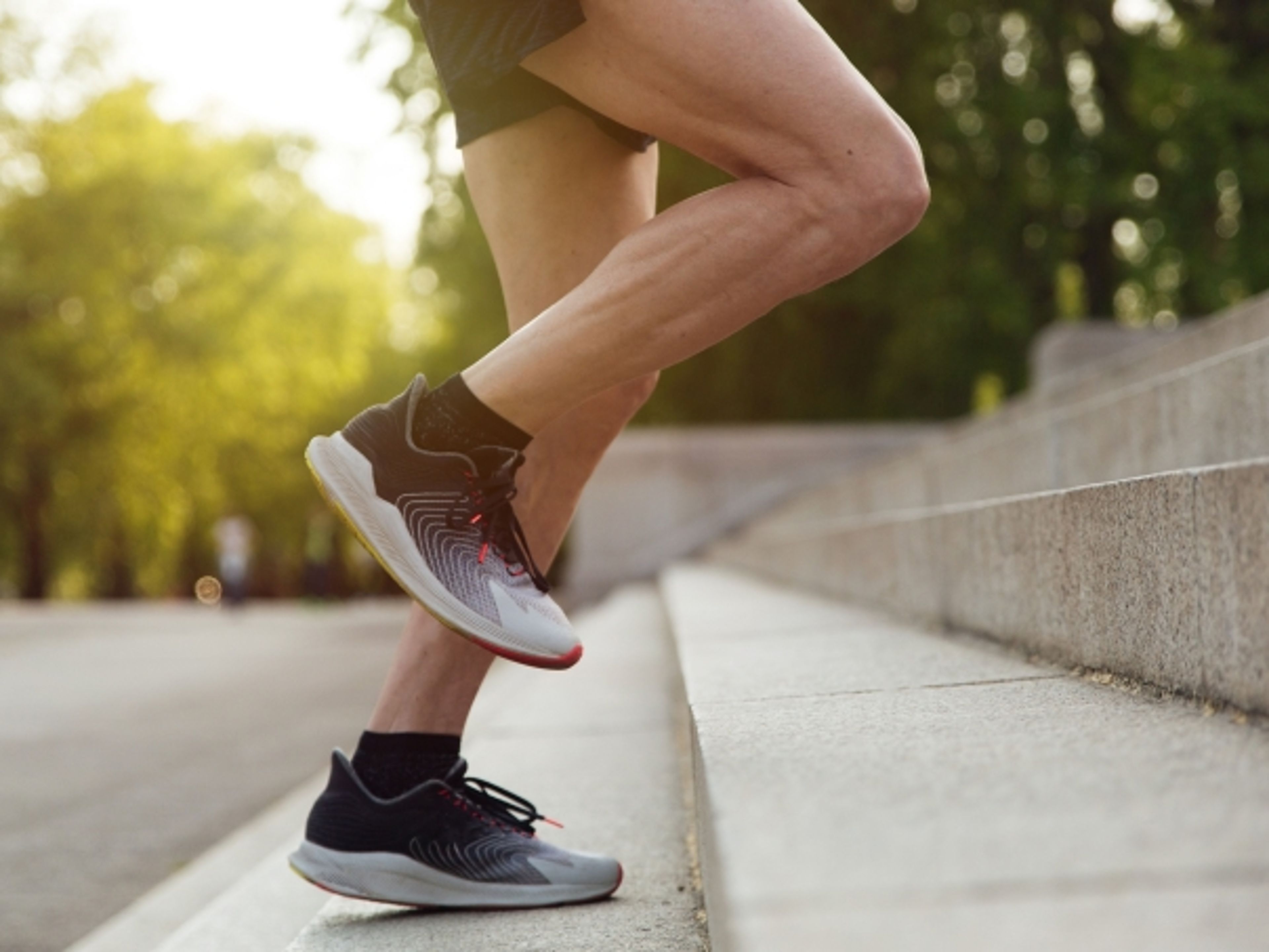 Runner's legs climbing outdoor steps