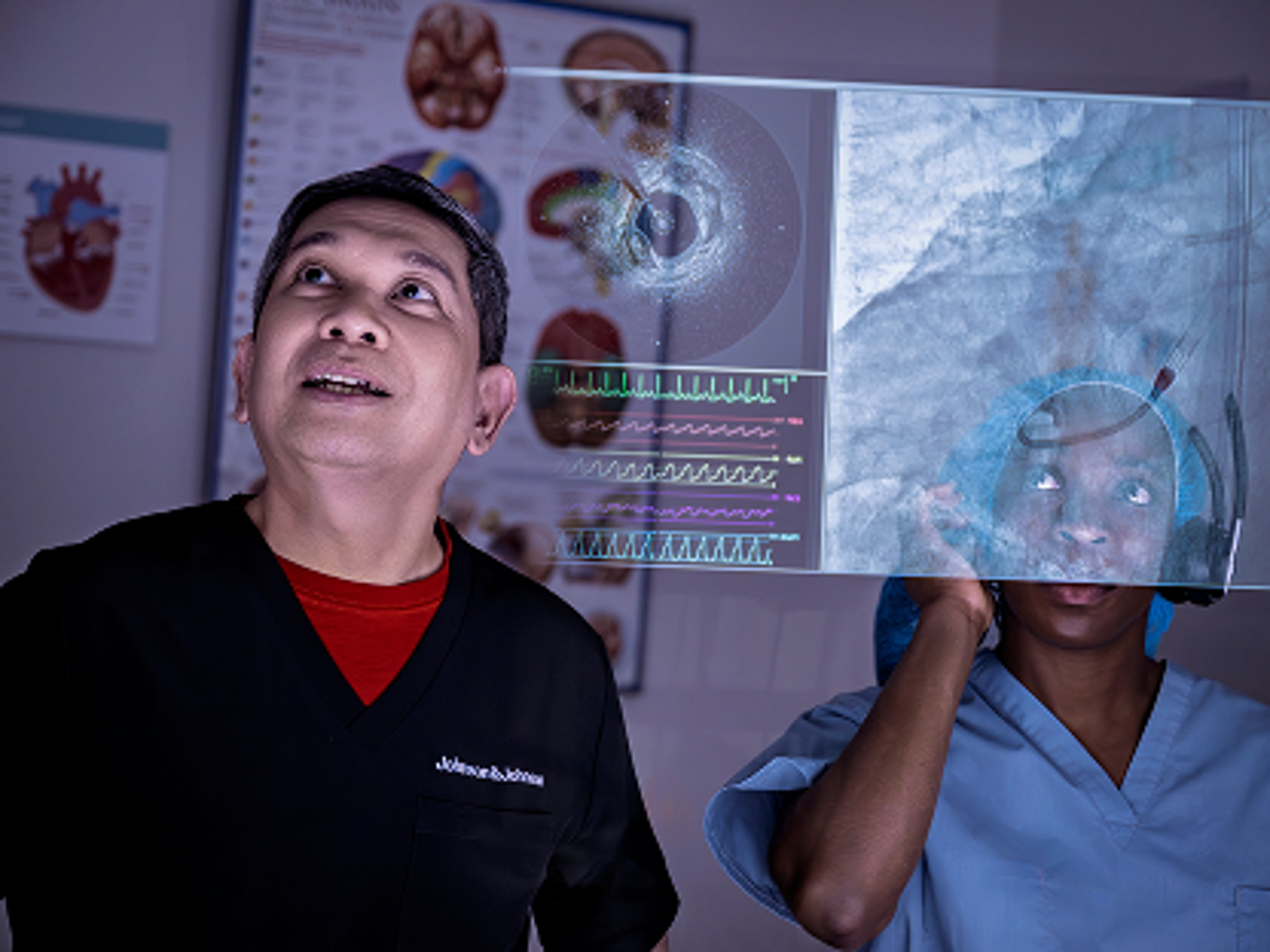 Clinicians in a control room review cardiac imaging and waveforms on a monitor while receiving instructions from the physician during use of an Impella heart pump.