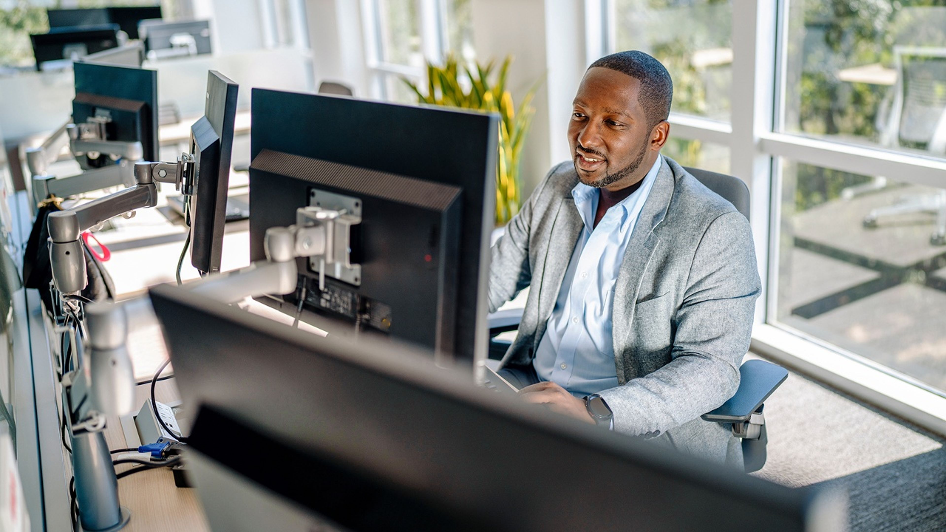 A man sitting at a desk in front of a computer