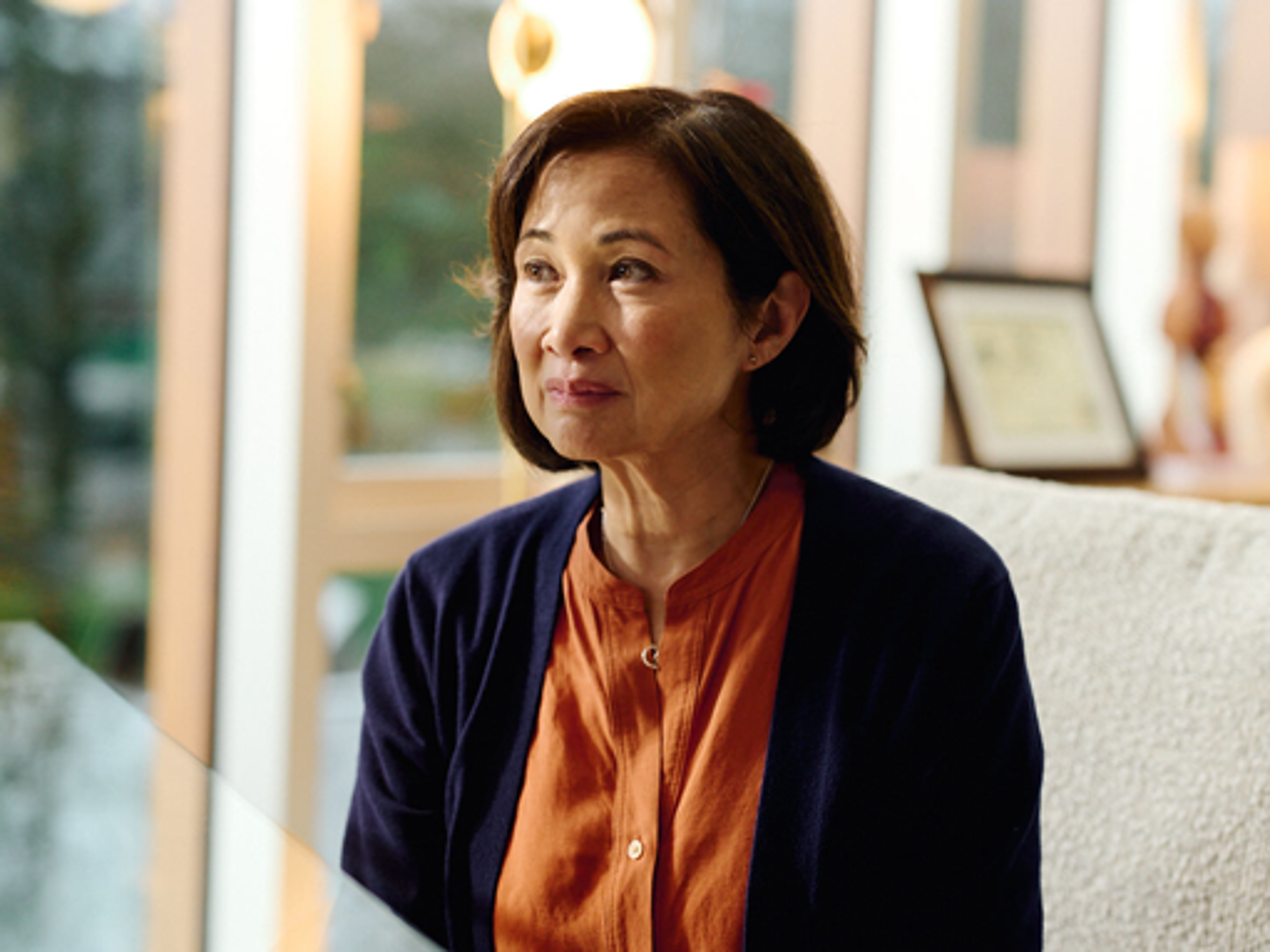 Woman seated and listening during a cardiologist consultation.