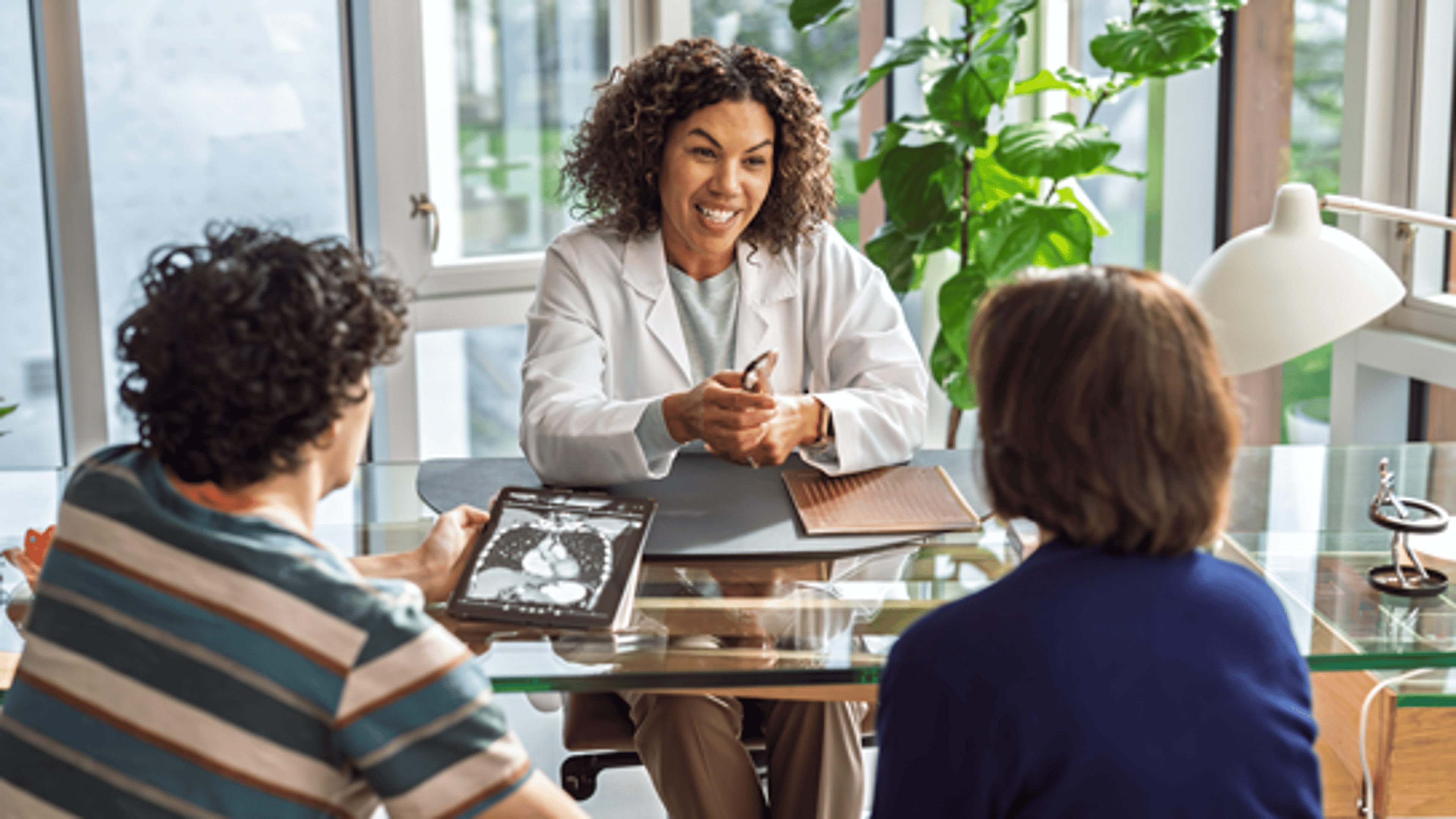 A physician having a consult with their patient and family