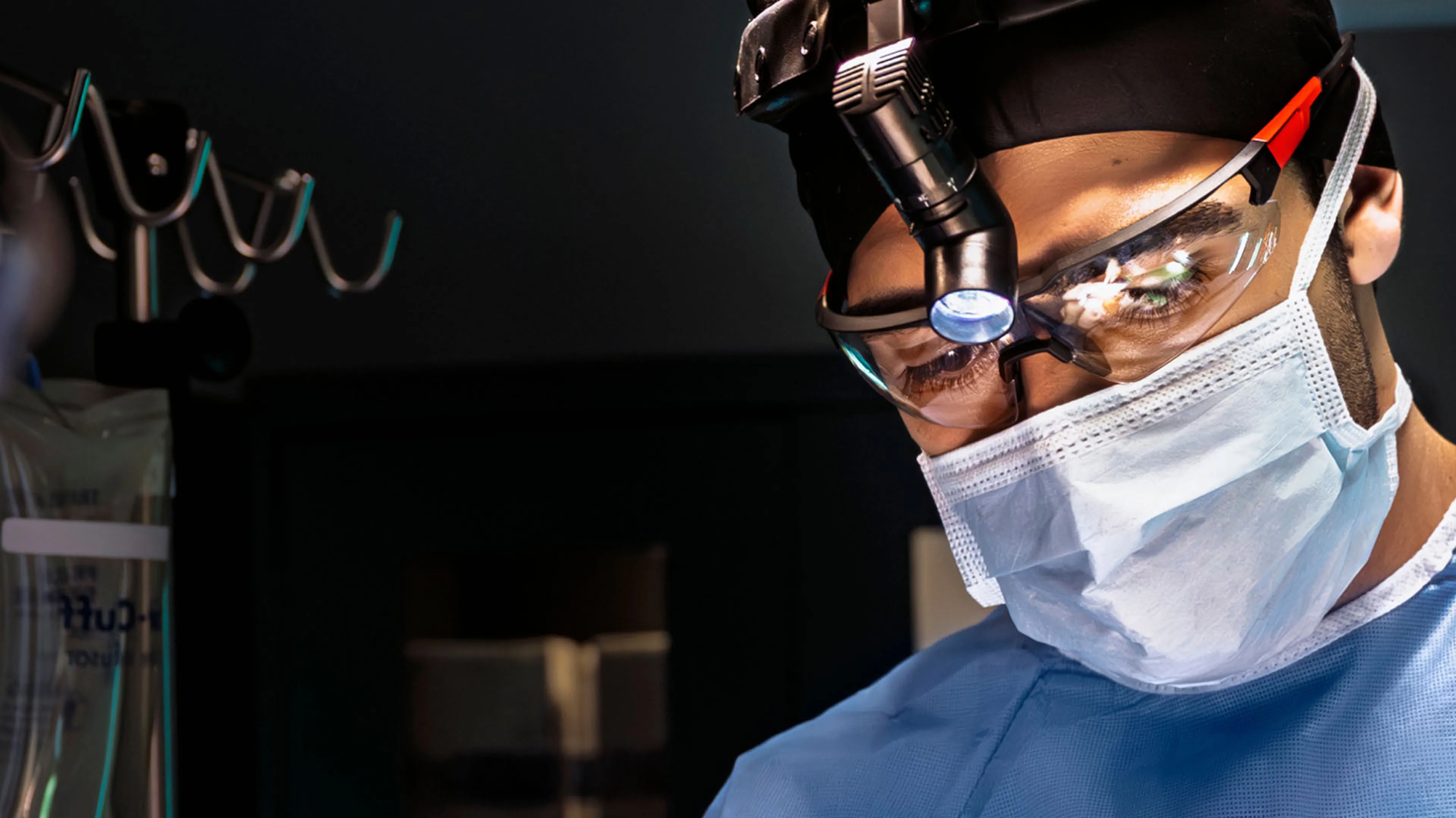 Surgeon looking focused while performing surgery.