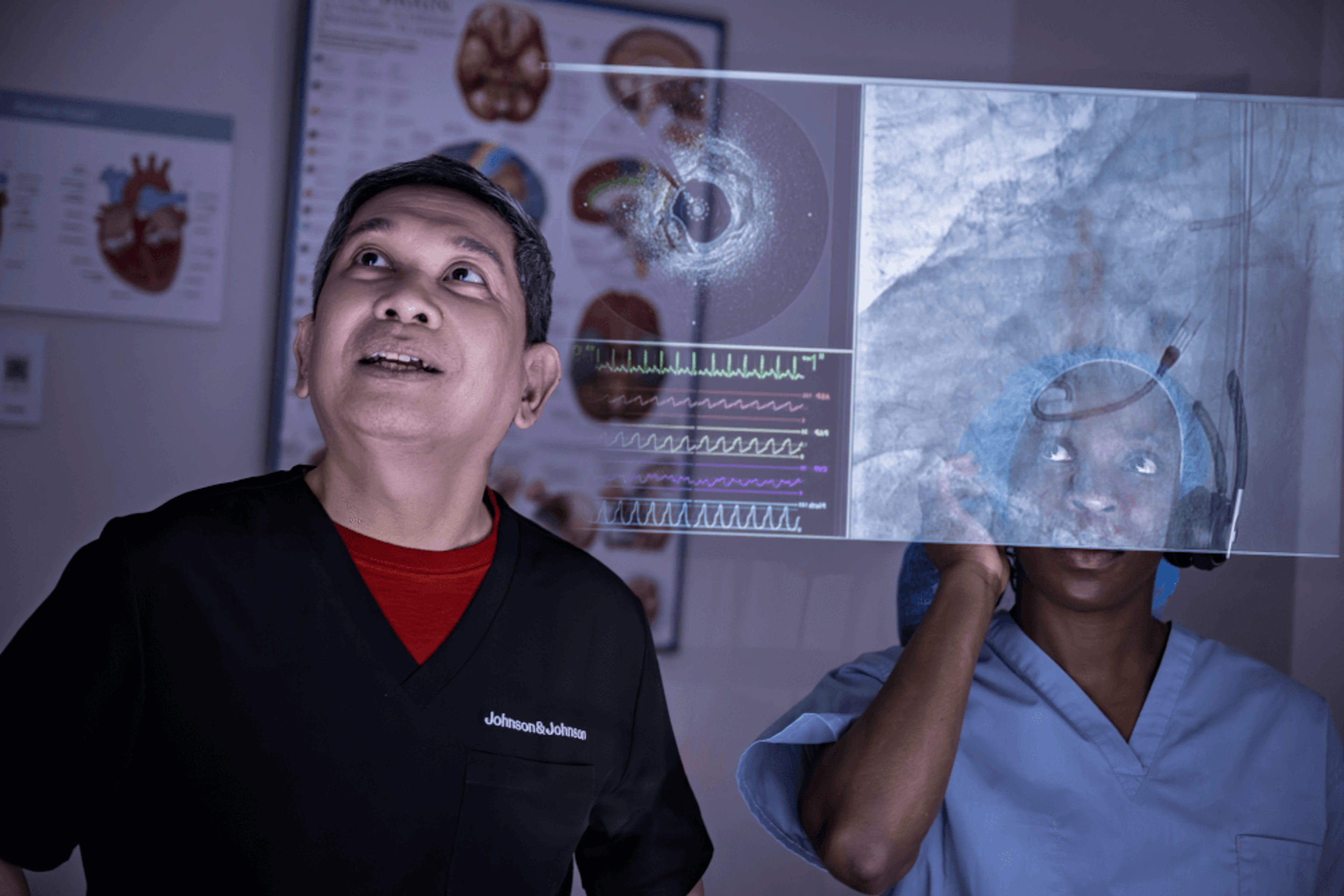 Clinicians in a control room review cardiac imaging and waveforms on a monitor while receiving instructions from the physician during use of an Impella heart pump.
